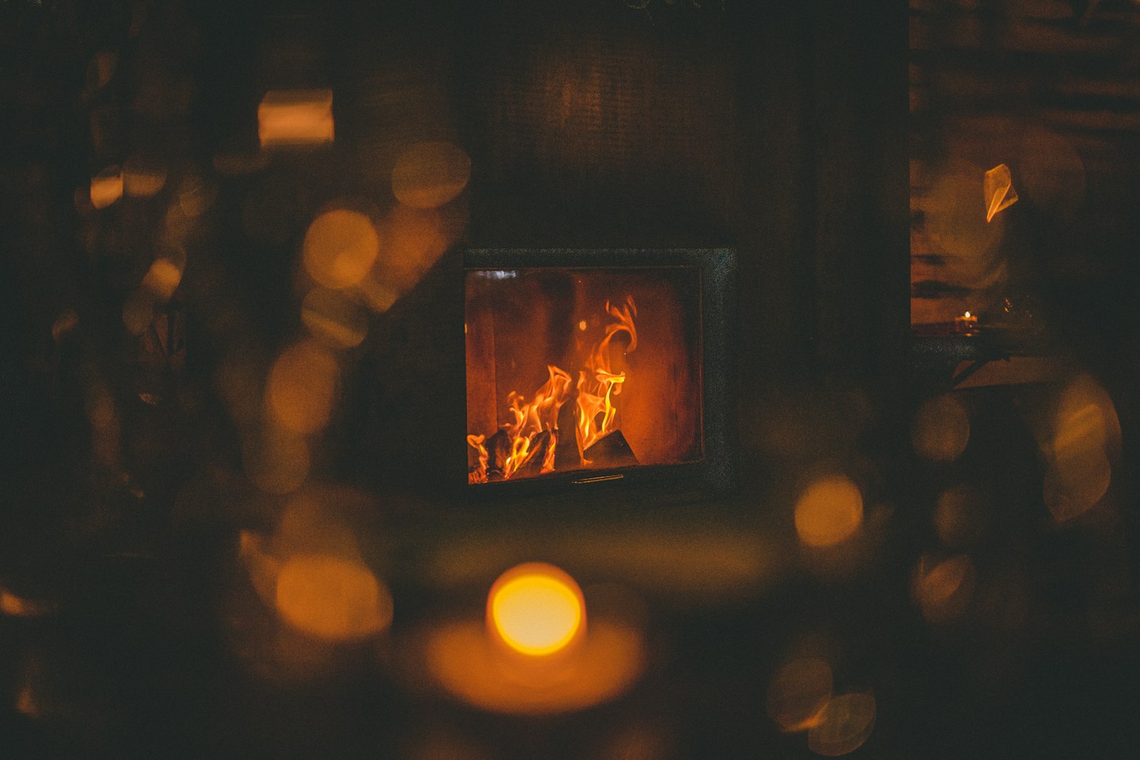 Friends raising warm spiced drinks around a fire on a winter evening.