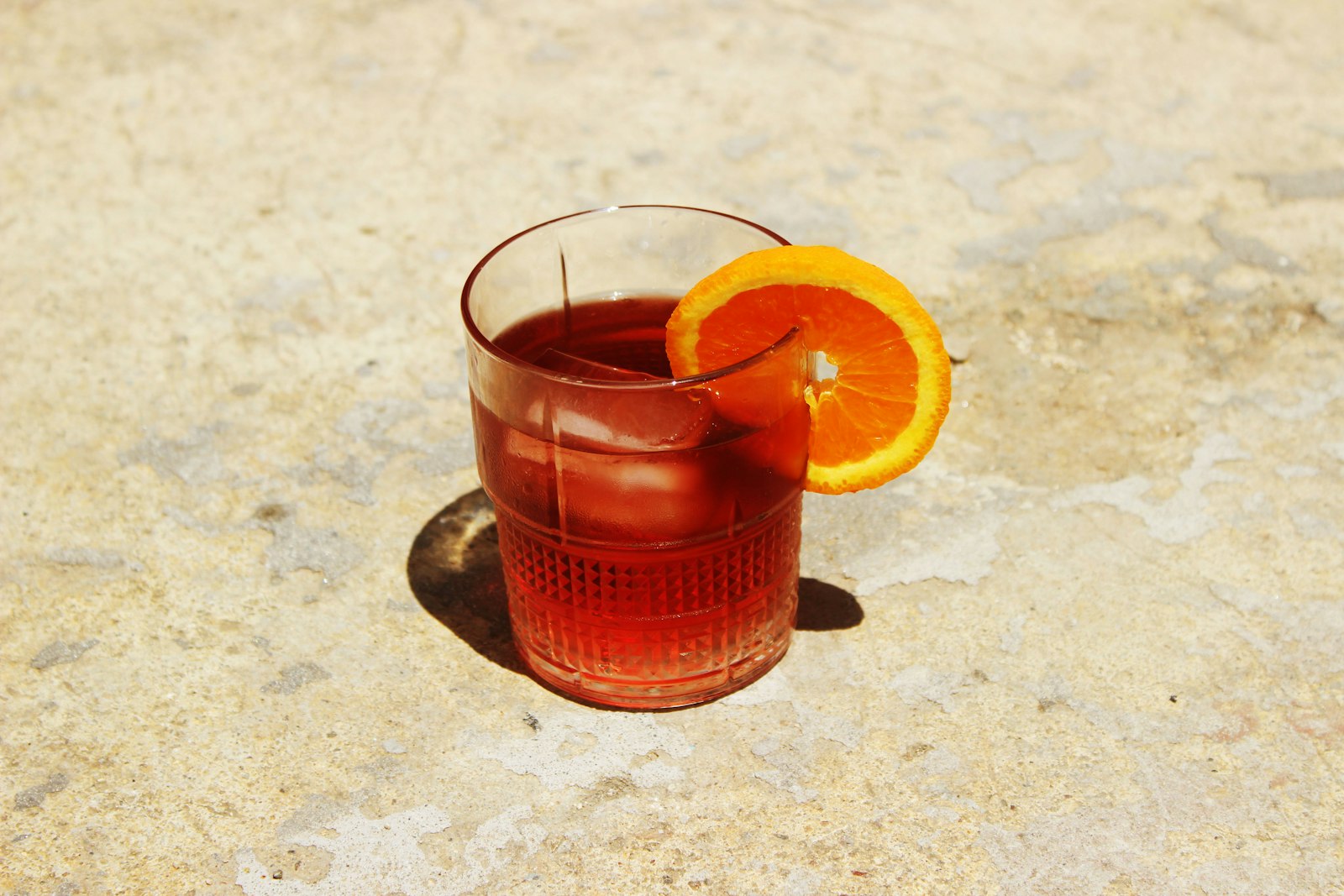 Bourbon cranberry punch in a heatproof mug with orange slice and floating cranberries