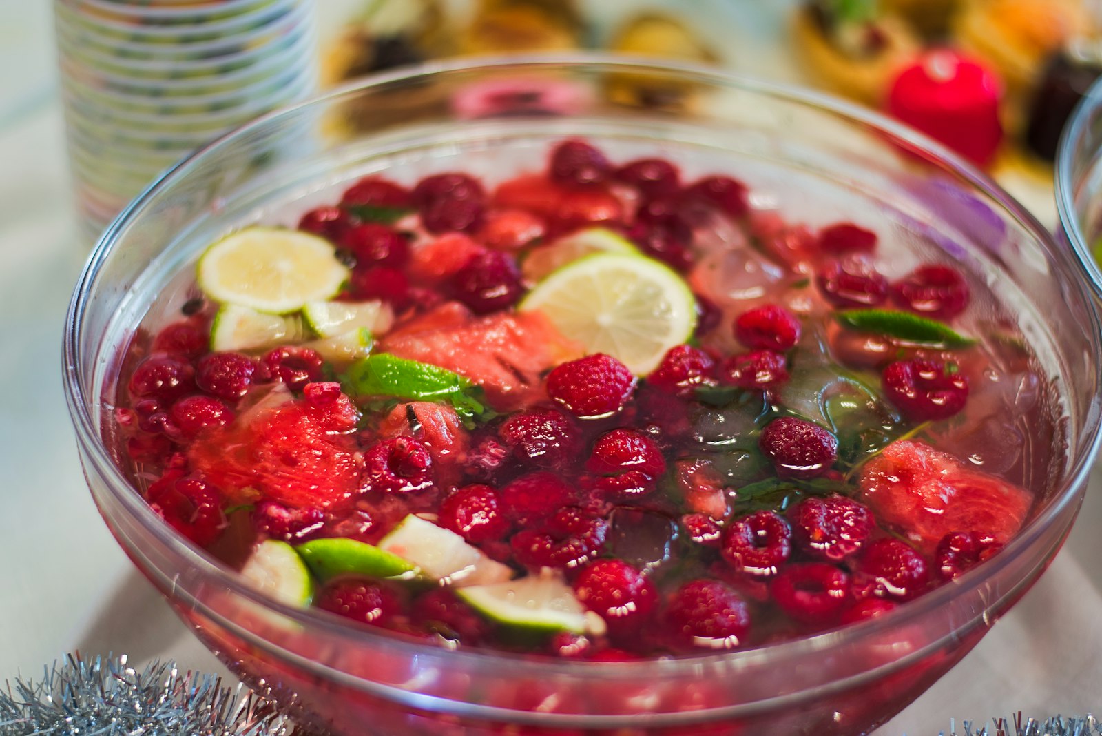 Warm Christmas punch in a heatproof bowl with apple slices, orange slices and cinnamon