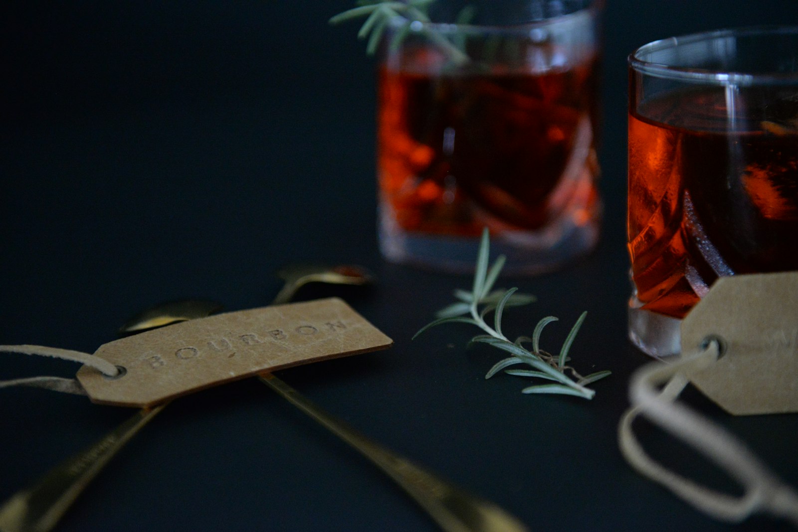 A green Christmas Tree Cocktail in a highball glass with a standing rosemary sprig
