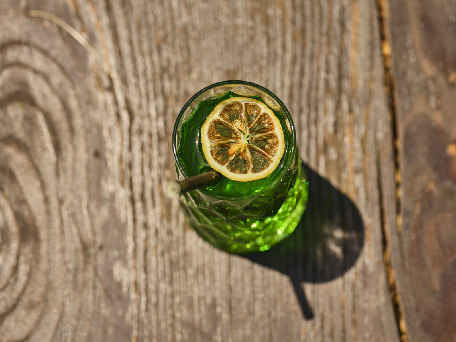 Fennel gin sour in a coupe with foam, bitters dots and a fennel frond