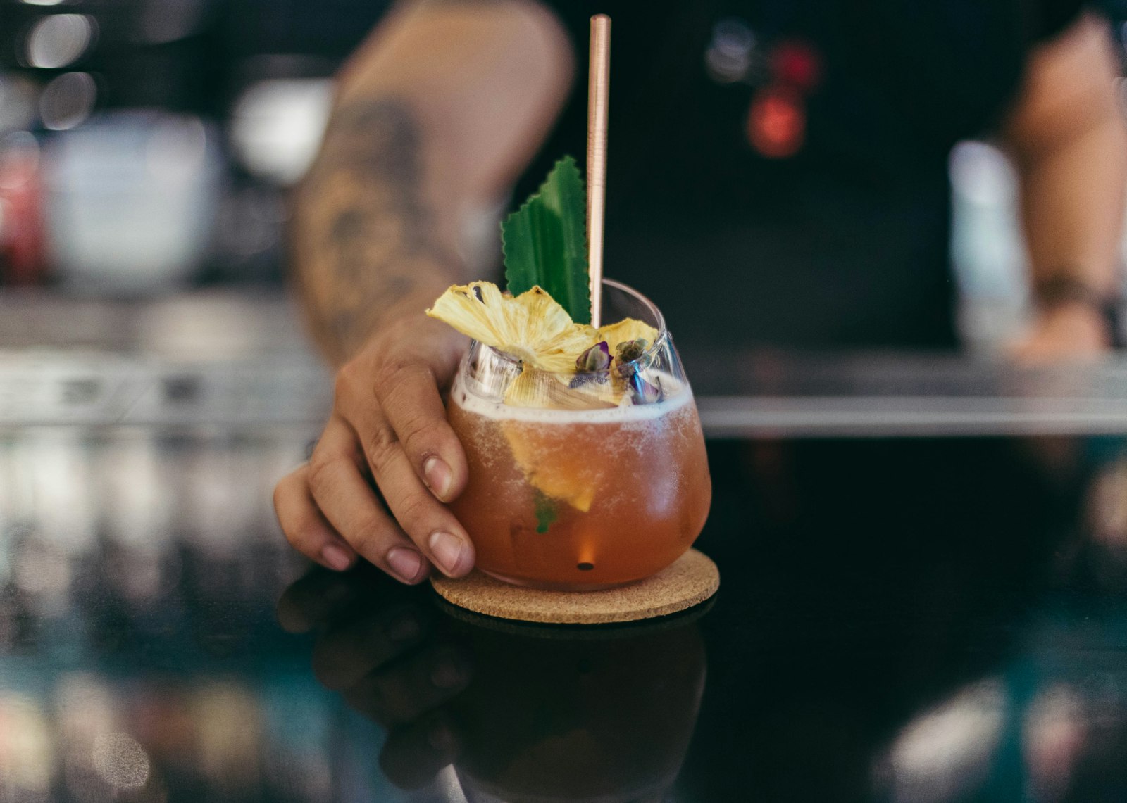 Fish House Punch in a glass bowl with lemon slices over a large block of ice