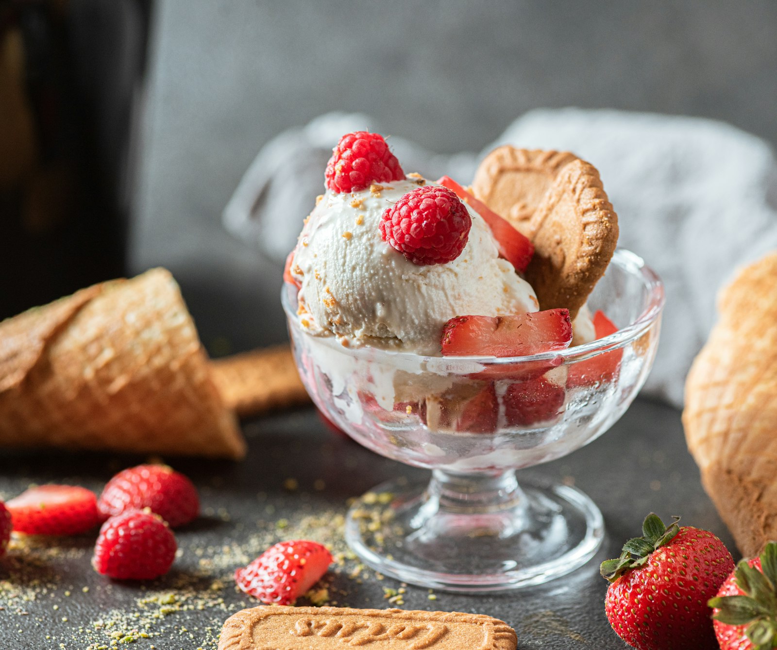 A heatproof glass of vanilla ice cream topped with hot raspberry sauce and whipped cream.