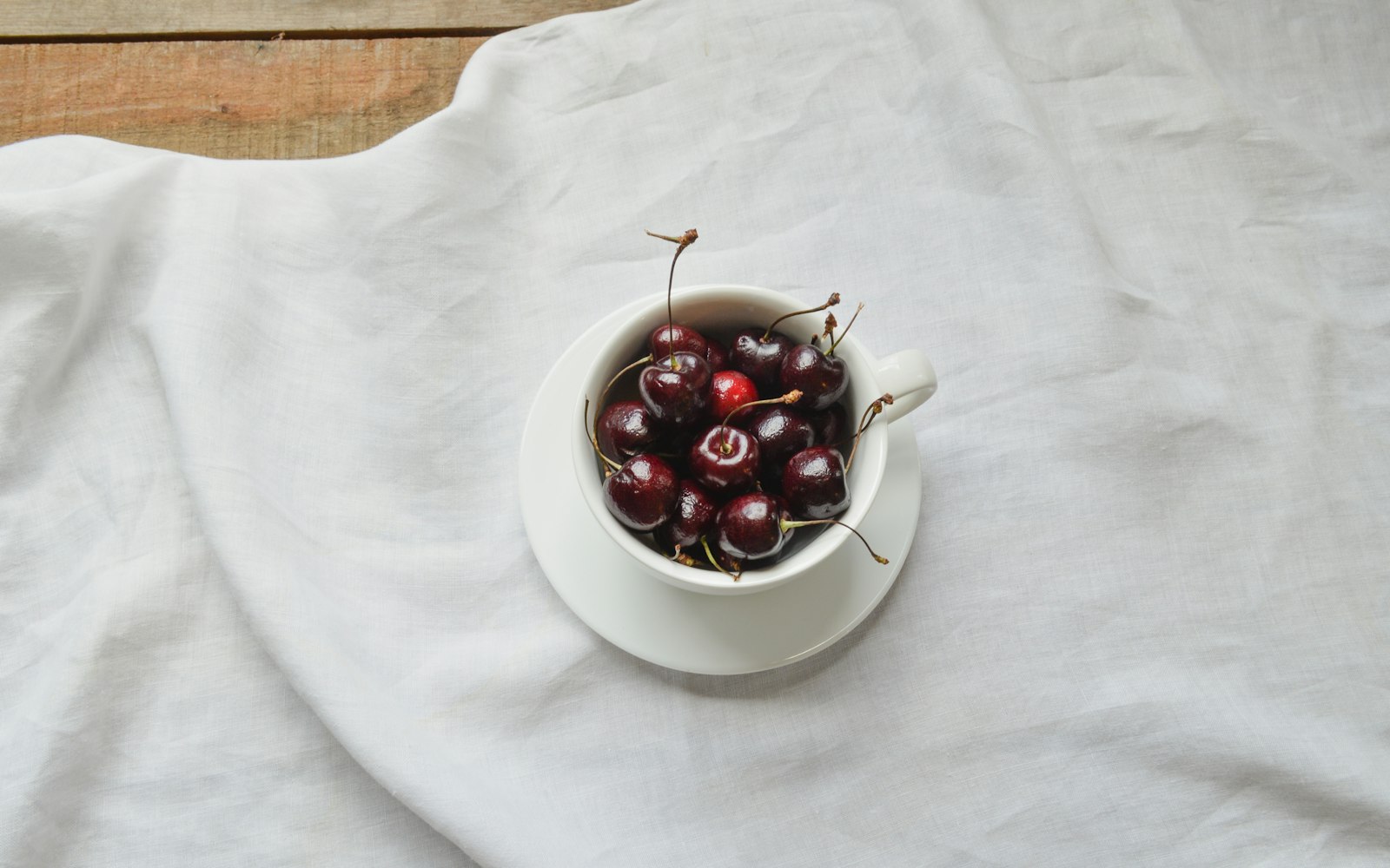 Hot cherry brandy toddy in a glass with lemon slice and cinnamon stick