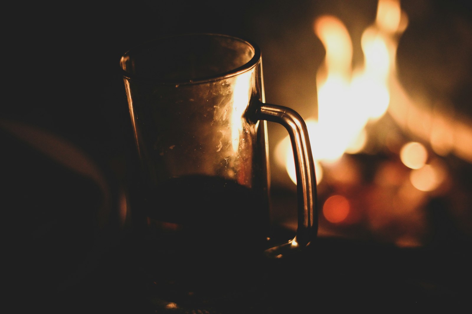 Hot cognac toddy in a glass with lemon slice and cinnamon stick