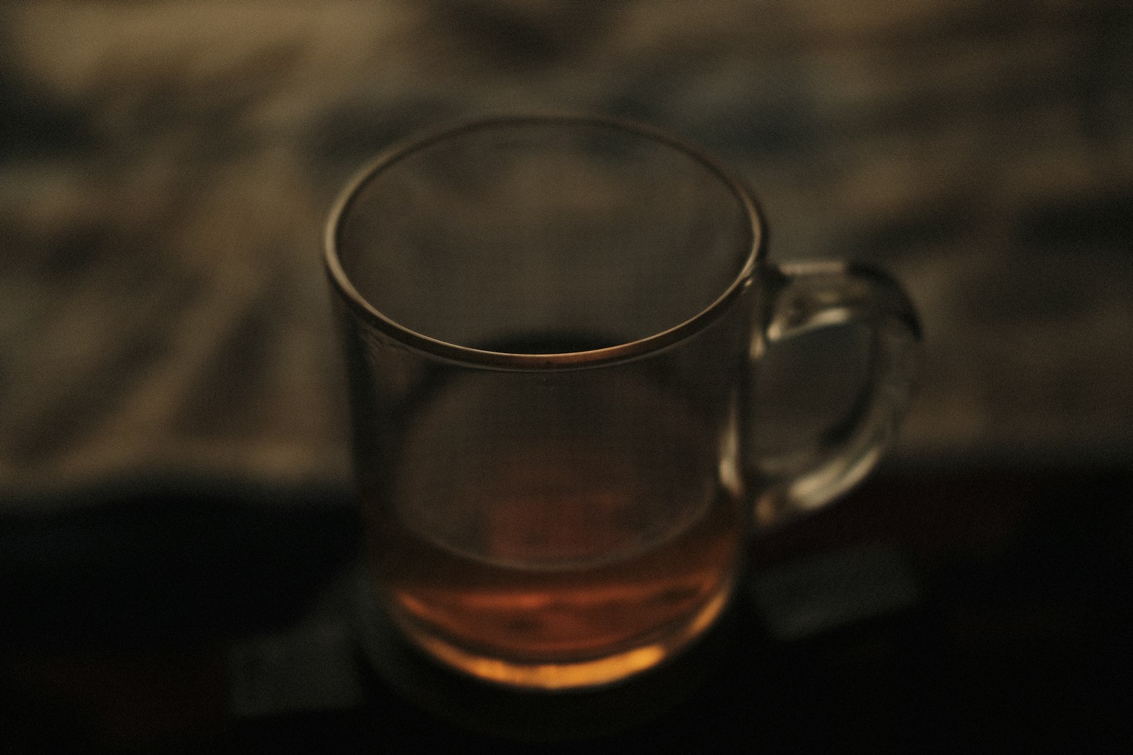 Heatproof mug of hot rum and butter with melting spiced butter batter and a cinnamon stick