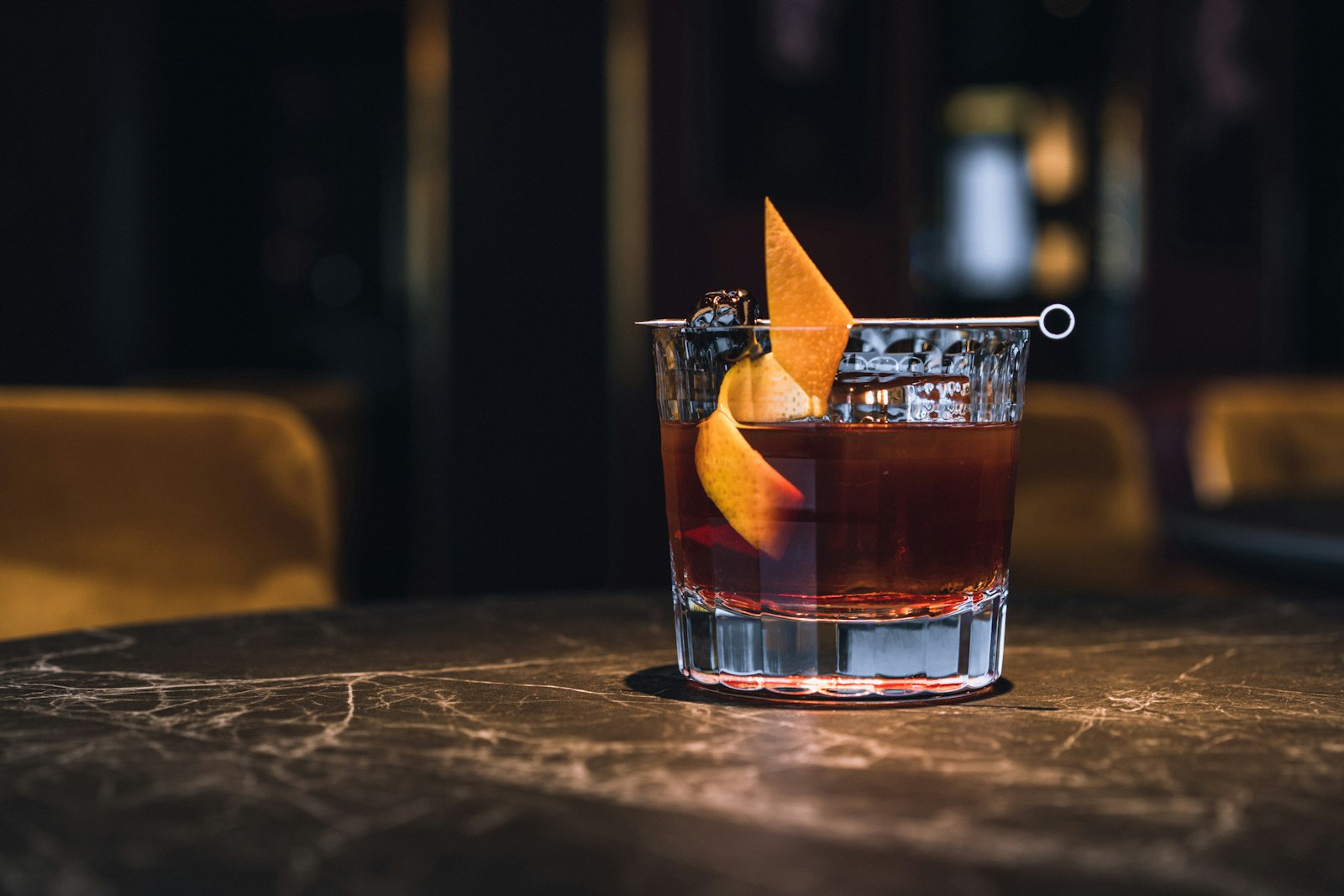 Wine glass of warm low-abv winter spritz with orange peel twist