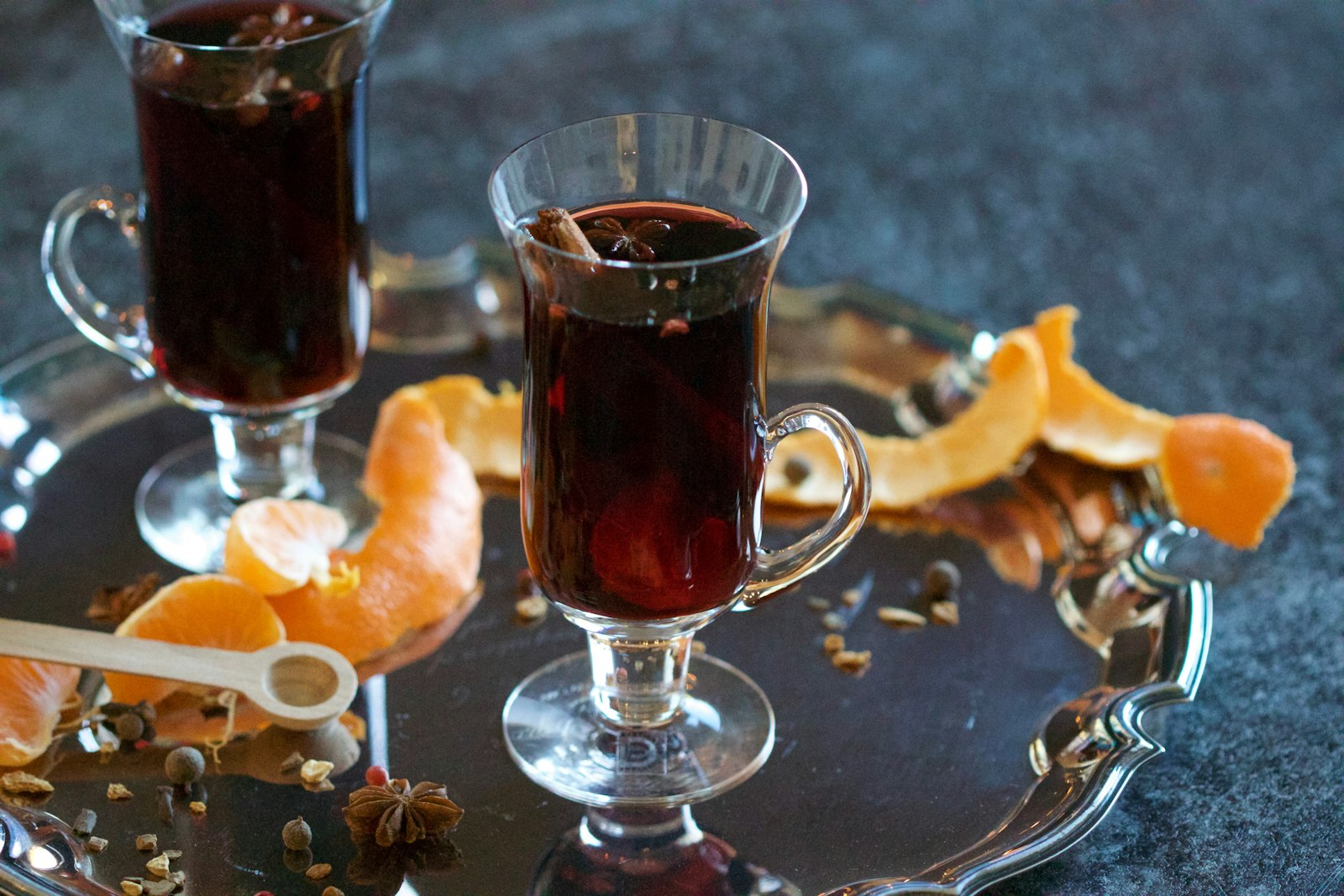 Mulled cherry wine in a heatproof glass with a cinnamon stick, star anise and cherries