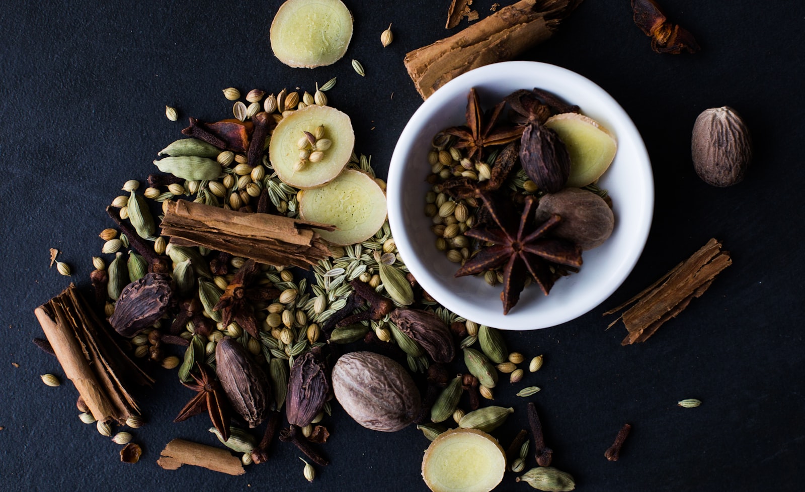 Warm mulled cider punch in a mug with apple slices, cinnamon and star anise
