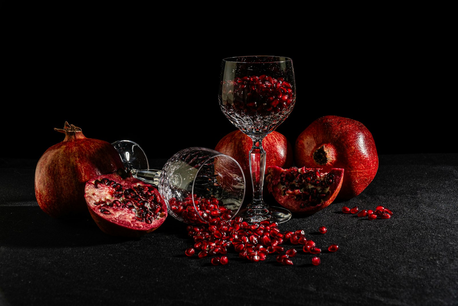 A ruby Pomegranate Christmas Martini in a chilled coupe with pomegranate seeds