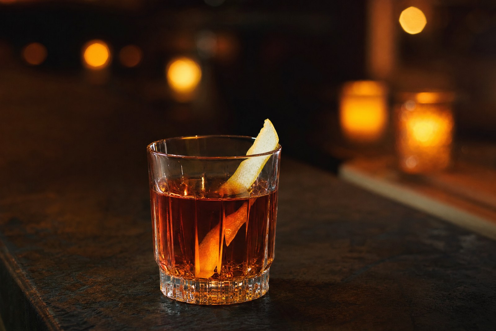 Sazerac cocktail in a rocks glass with an absinthe rinse and lemon peel garnish