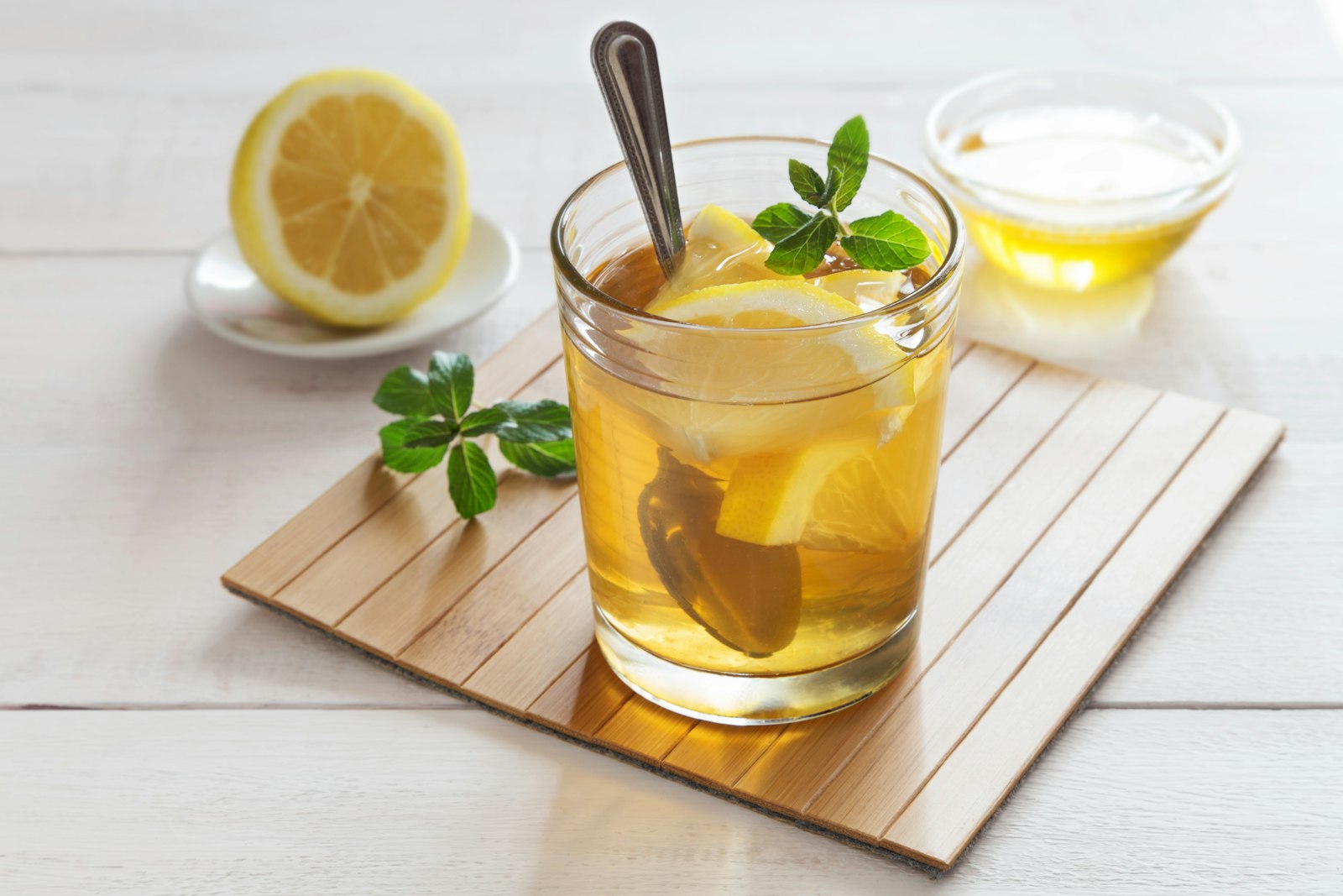 Warm gin and honey served in a heatproof glass with a cinnamon stick