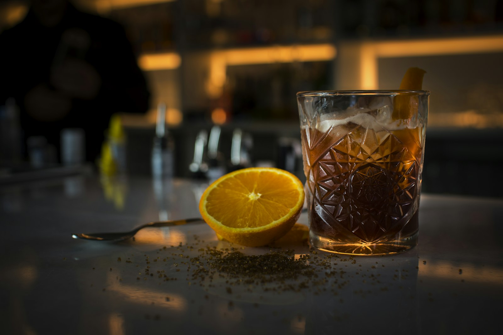Warm sloe and spice gin cocktail with a cinnamon stick and cloves floating in the glass