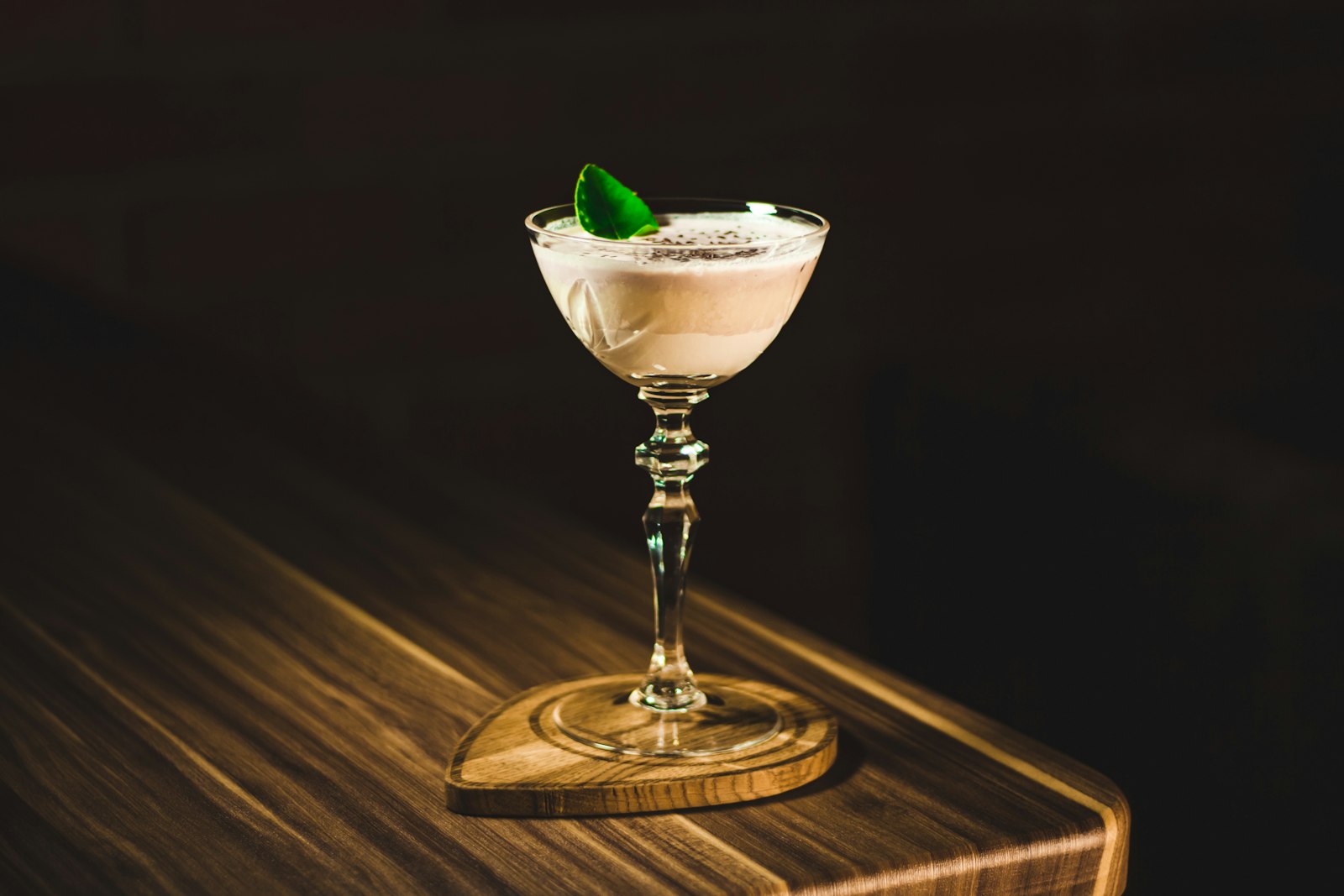 Rocks glass of white russian with cream floating on dark coffee liqueur over ice