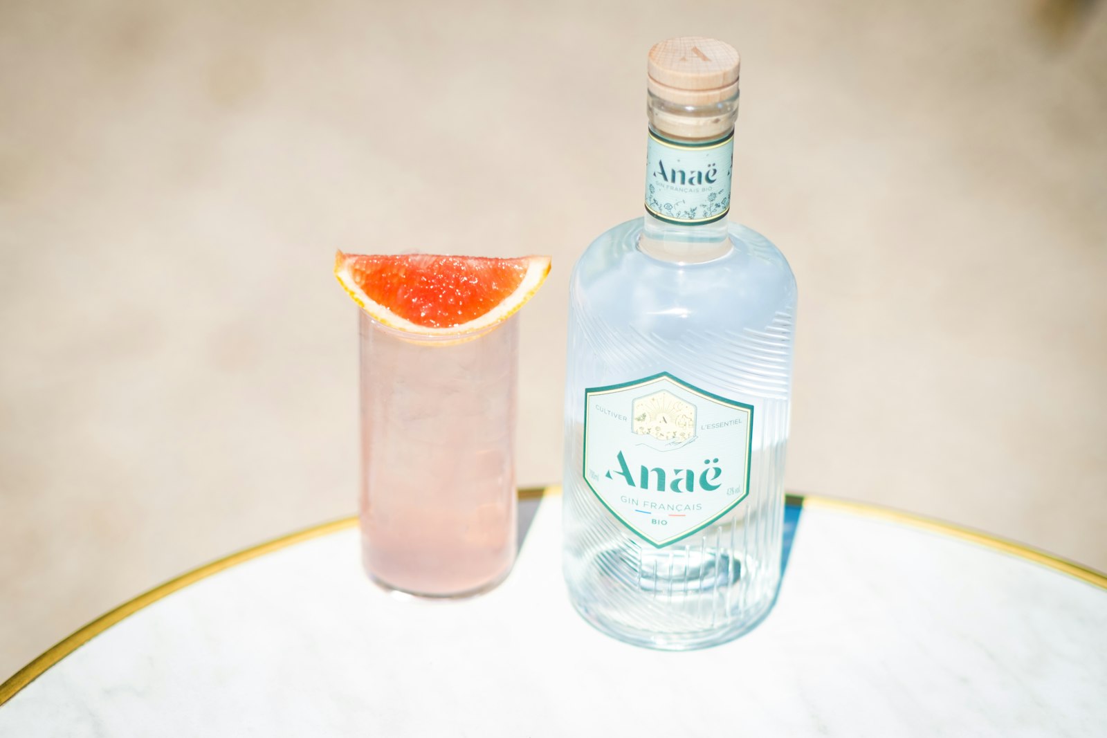 Warm Winter Paloma in a stemmed glass with salted rim and grapefruit twist